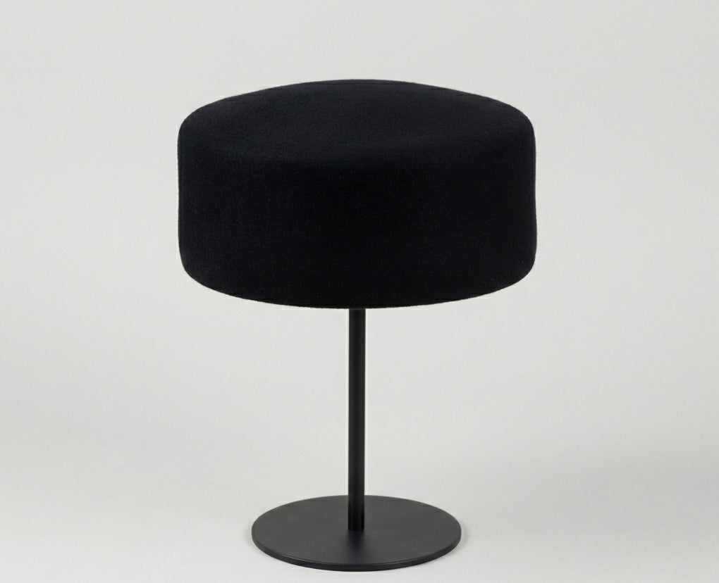 black pillbox hat on stand