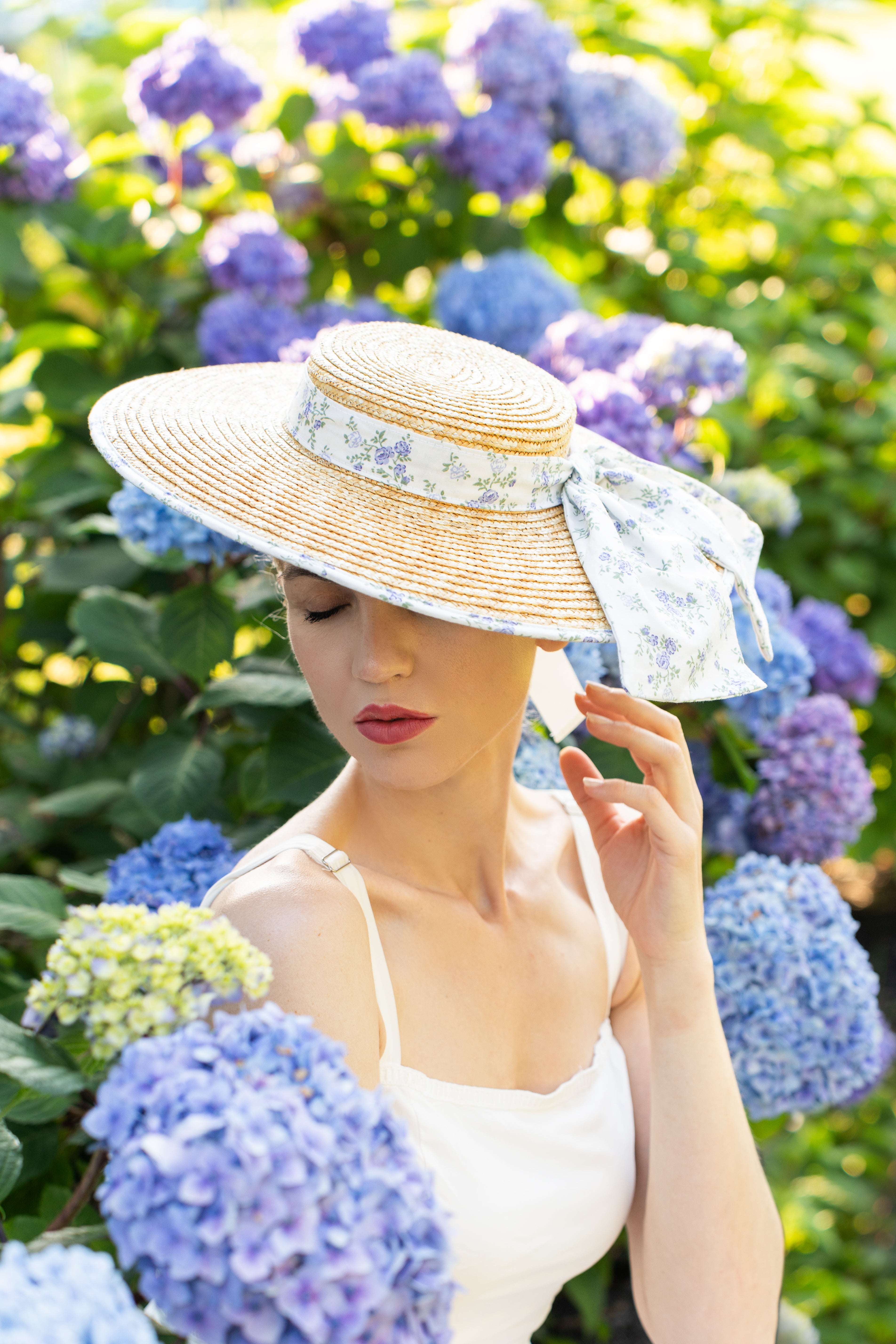 woman in garden wearing a straw hat